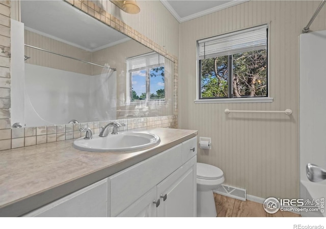 2840 W 21st St Unit 7, Greeley, CO 80634 - bathroom featuring ornamental molding, a shower, vanity, wood finished floors, and tasteful backsplash