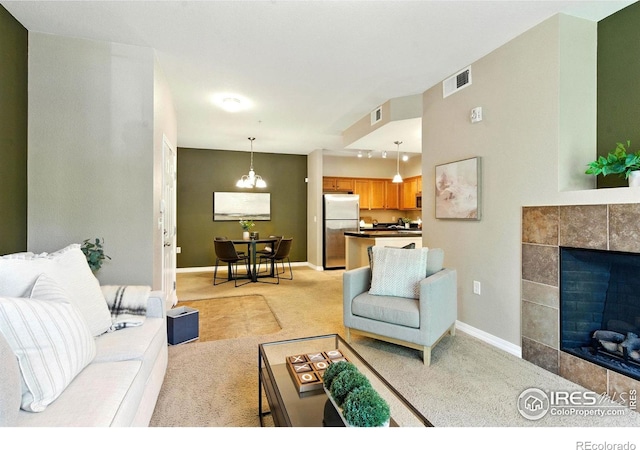 2450 Windrow Dr Unit E106, Fort Collins, CO 80525 - living room featuring light carpet and a tiled fireplace