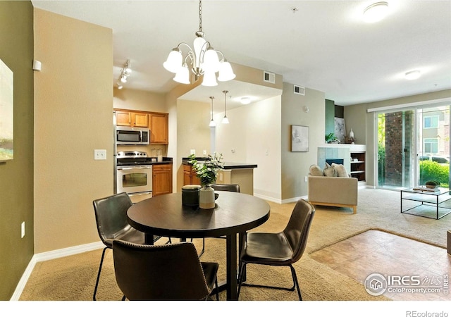 2450 Windrow Dr Unit E106, Fort Collins, CO 80525 - dining area with light colored carpet and a chandelier