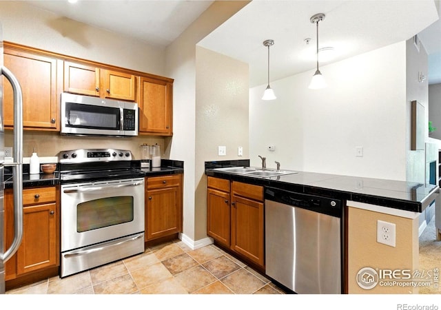 2450 Windrow Dr Unit E106, Fort Collins, CO 80525 - kitchen featuring appliances with stainless steel finishes, a peninsula, and brown cabinetry