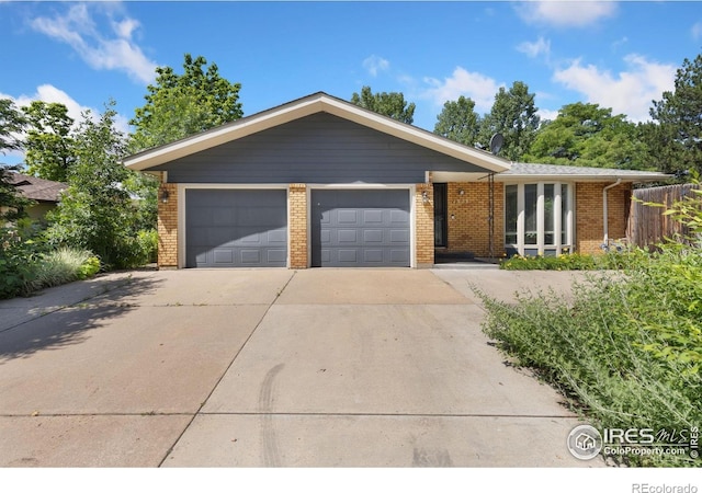 1323 Horizon Ln, Longmont, CO 80501 - ranch-style home featuring concrete driveway, brick siding, and an attached garage
