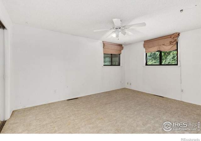 1323 Horizon Ln, Longmont, CO 80501 - empty room with carpet, ceiling fan, and a textured ceiling