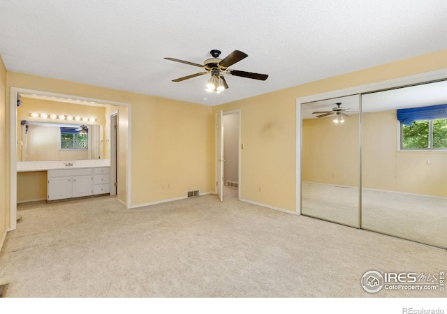 1323 Horizon Ln, Longmont, CO 80501 - unfurnished bedroom with carpet flooring, connected bathroom, a closet, and ceiling fan
