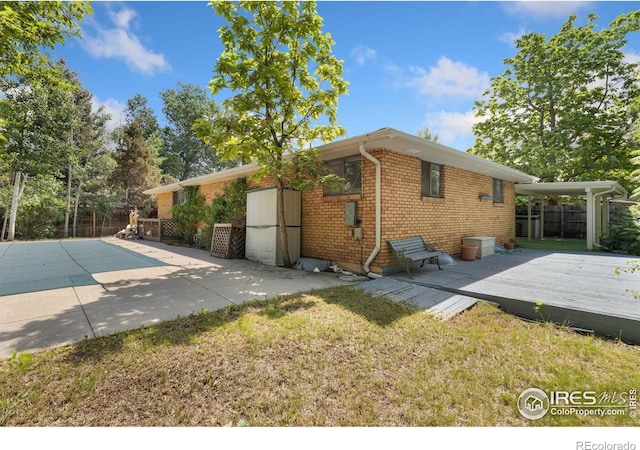 1323 Horizon Ln, Longmont, CO 80501 - view of home's exterior featuring a deck and brick siding