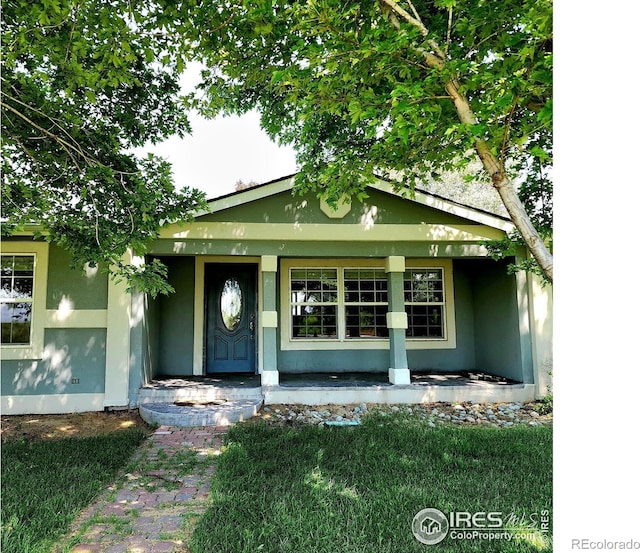 18082 County Road 25, Brush, CO 80723 - property entrance featuring covered porch and stucco siding