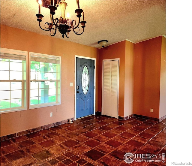 18082 County Road 25, Brush, CO 80723 - entrance foyer featuring a textured ceiling and a chandelier