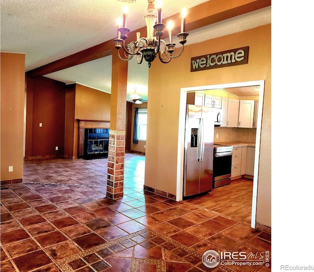 18082 County Road 25, Brush, CO 80723 - kitchen featuring stainless steel appliances, white cabinets, a chandelier, light countertops, and a fireplace