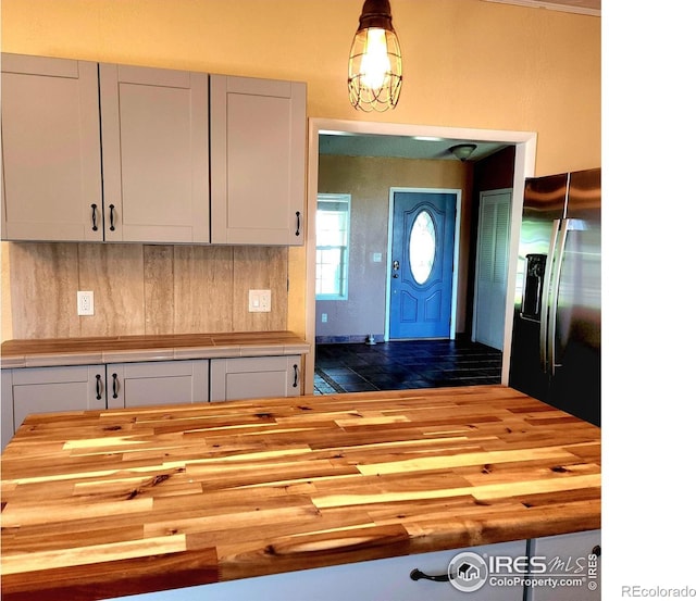 18082 County Road 25, Brush, CO 80723 - kitchen with wood counters, stainless steel fridge with ice dispenser, white cabinetry, and tasteful backsplash