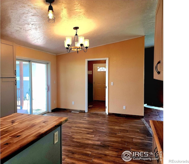 18082 County Road 25, Brush, CO 80723 - unfurnished dining area with a textured ceiling, dark wood-style flooring, and a chandelier