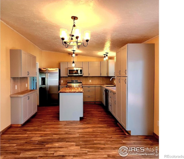 18082 County Road 25, Brush, CO 80723 - kitchen with appliances with stainless steel finishes, a chandelier, a textured ceiling, a kitchen island, and dark wood-style flooring