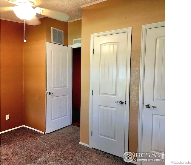 18082 County Road 25, Brush, CO 80723 - unfurnished bedroom featuring dark carpet, a textured ceiling, and crown molding