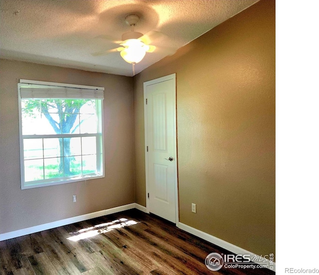 18082 County Road 25, Brush, CO 80723 - unfurnished room with dark wood-style floors, ceiling fan, and a textured ceiling