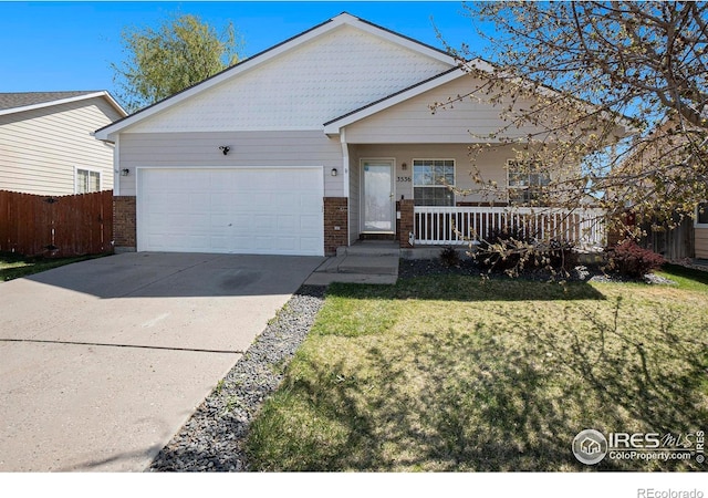 3536 38th Ave, Evans, CO 80620 - view of front of property with brick siding, a garage, covered porch, and driveway