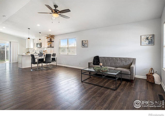 3536 38th Ave, Evans, CO 80620 - living room featuring plenty of natural light, vaulted ceiling, a ceiling fan, dark wood-style flooring, and recessed lighting