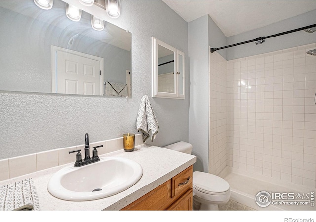 3536 38th Ave, Evans, CO 80620 - full bathroom with a tile shower, vanity, and a textured wall
