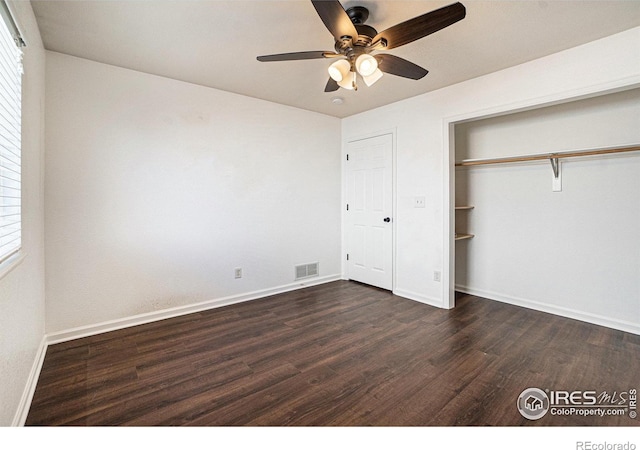 3536 38th Ave, Evans, CO 80620 - unfurnished bedroom with dark wood-type flooring, a closet, and a ceiling fan