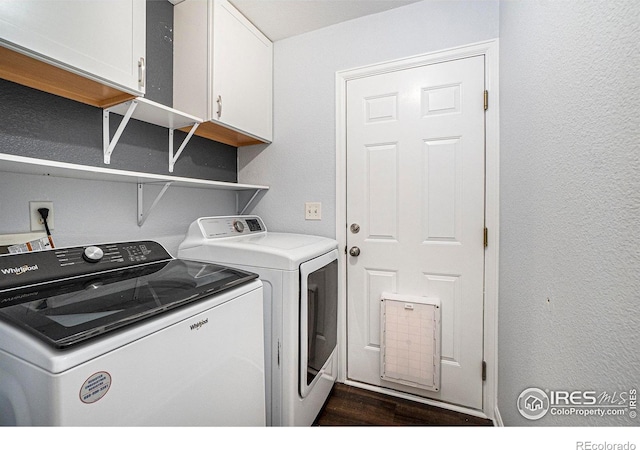3536 38th Ave, Evans, CO 80620 - laundry room featuring cabinet space, washing machine and clothes dryer, and dark wood-type flooring