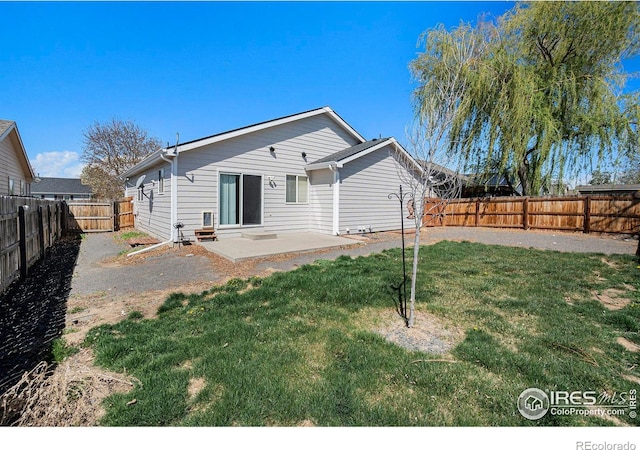 3536 38th Ave, Evans, CO 80620 - back of property with a patio area and a fenced backyard