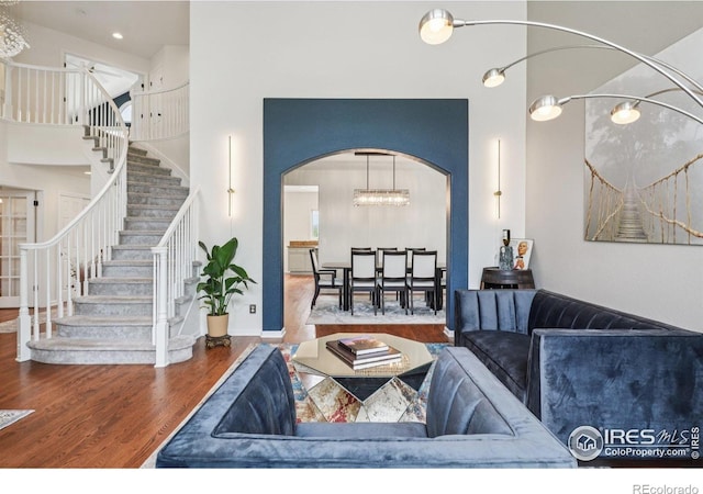 345 Onyx Way, Superior, CO 80027 - living area with wood finished floors, stairs, arched walkways, and a towering ceiling