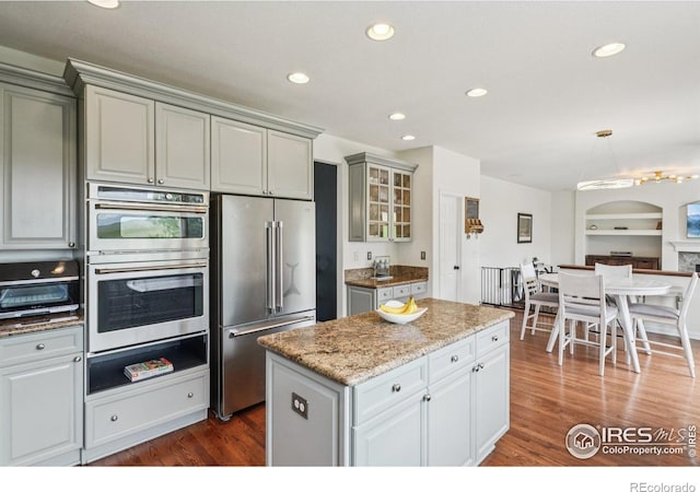 345 Onyx Way, Superior, CO 80027 - kitchen featuring appliances with stainless steel finishes, gray cabinetry, recessed lighting, a warming drawer, and dark wood-type flooring