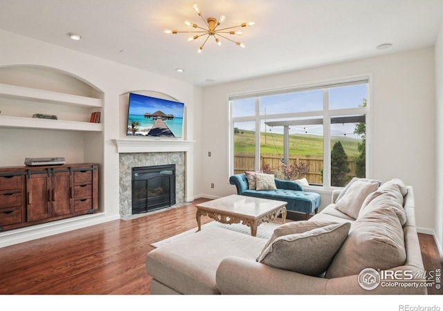 345 Onyx Way, Superior, CO 80027 - living area with wood finished floors, a chandelier, a fireplace with flush hearth, built in features, and recessed lighting