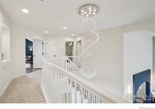 345 Onyx Way, Superior, CO 80027 - hall featuring carpet floors, an upstairs landing, recessed lighting, and a chandelier