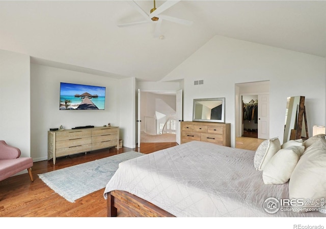 345 Onyx Way, Superior, CO 80027 - bedroom featuring high vaulted ceiling, wood finished floors, a ceiling fan, and a walk in closet