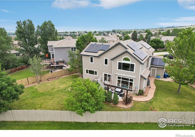 345 Onyx Way, Superior, CO 80027 - rear view of property featuring roof mounted solar panels, a fenced backyard, and a residential view