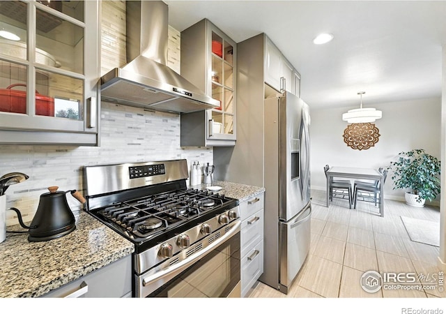 1217 Sycamore St, Fort Collins, CO 80521 - kitchen featuring wall chimney range hood, stainless steel appliances, tasteful backsplash, light tile patterned floors, and glass insert cabinets