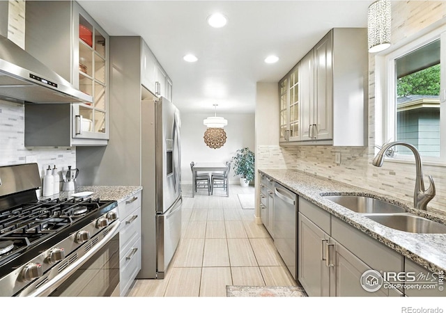 1217 Sycamore St, Fort Collins, CO 80521 - kitchen with appliances with stainless steel finishes, wall chimney range hood, gray cabinets, tasteful backsplash, and recessed lighting