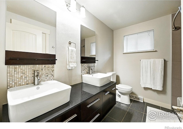 1217 Sycamore St, Fort Collins, CO 80521 - bathroom featuring tasteful backsplash, double vanity, and tile patterned flooring