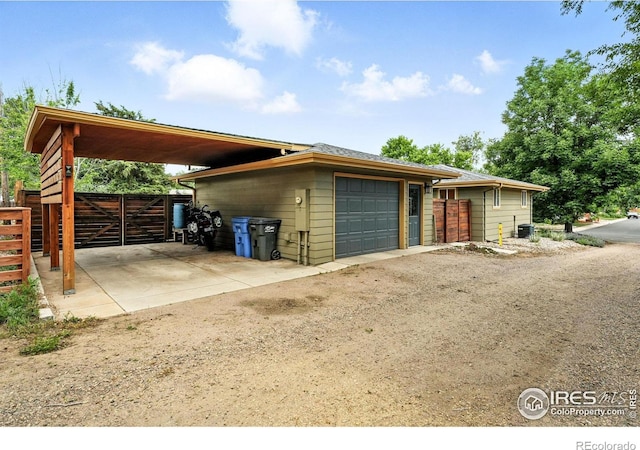 1217 Sycamore St, Fort Collins, CO 80521 - view of side of property with a detached garage and dirt driveway