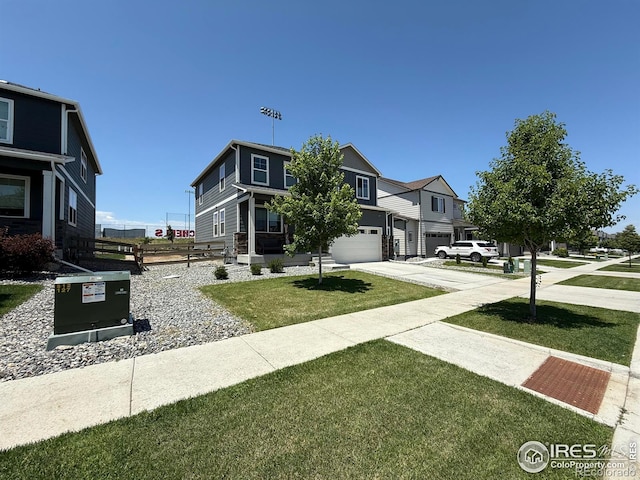 117 N 66th Ave, Greeley, CO 80634 - view of front of home with driveway, a garage, and a front lawn