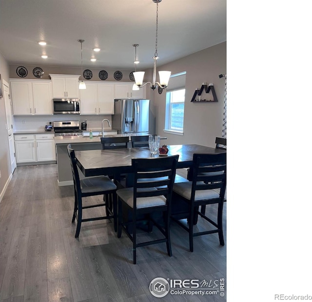 117 N 66th Ave, Greeley, CO 80634 - dining space with dark wood-type flooring, a chandelier, and recessed lighting