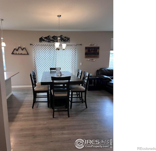 117 N 66th Ave, Greeley, CO 80634 - dining space featuring a chandelier and dark wood-style flooring