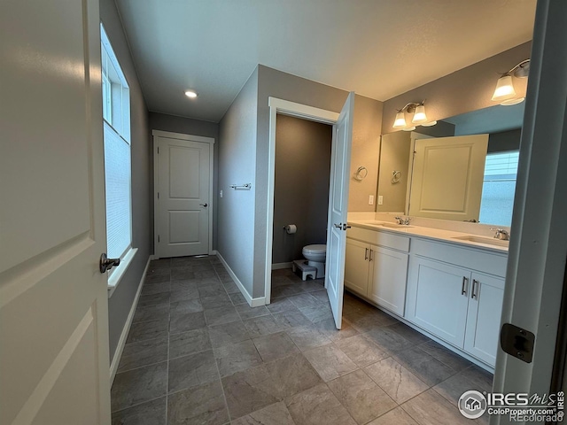 117 N 66th Ave, Greeley, CO 80634 - full bathroom featuring double vanity and baseboards