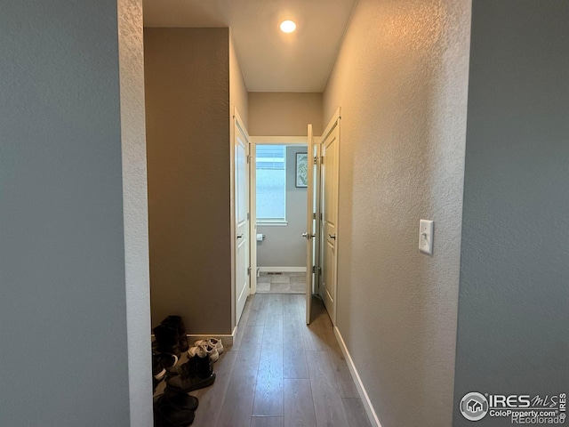 117 N 66th Ave, Greeley, CO 80634 - corridor featuring a textured wall and wood-type flooring