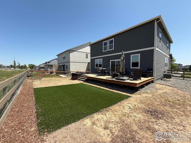 117 N 66th Ave, Greeley, CO 80634 - rear view of house featuring a deck and a fenced backyard