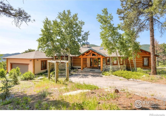 24043 Eagle Cliff Trl, Conifer, CO 80433 - log-style house featuring a garage and stone siding