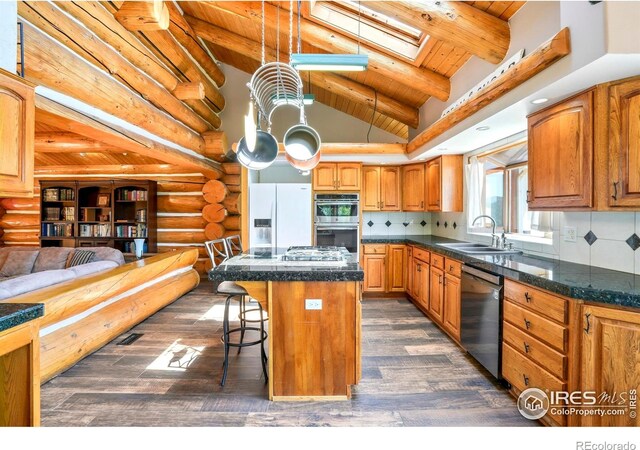 24043 Eagle Cliff Trl, Conifer, CO 80433 - kitchen with stainless steel appliances, wood ceiling, dark wood finished floors, a skylight, and a center island