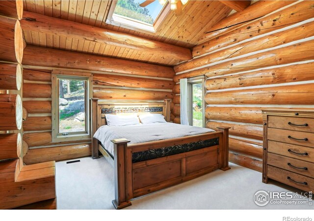 24043 Eagle Cliff Trl, Conifer, CO 80433 - carpeted bedroom featuring a wood ceiling with exposed beams and a skylight