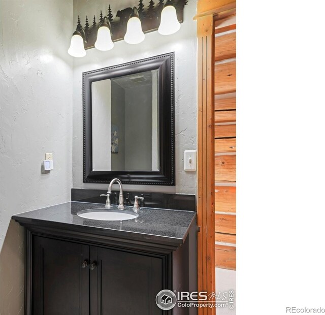 24043 Eagle Cliff Trl, Conifer, CO 80433 - bathroom with a textured wall and vanity
