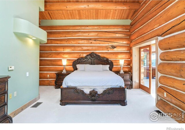 24043 Eagle Cliff Trl, Conifer, CO 80433 - bedroom with carpet floors, a wood ceiling with exposed beams, access to outside, and rustic walls