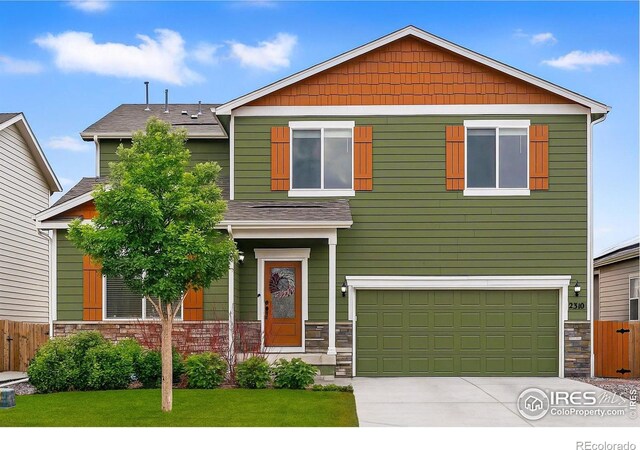 2310 Angus St, Mead, CO 80542 - view of front of house with an attached garage, concrete driveway, stone siding, and a shingled roof