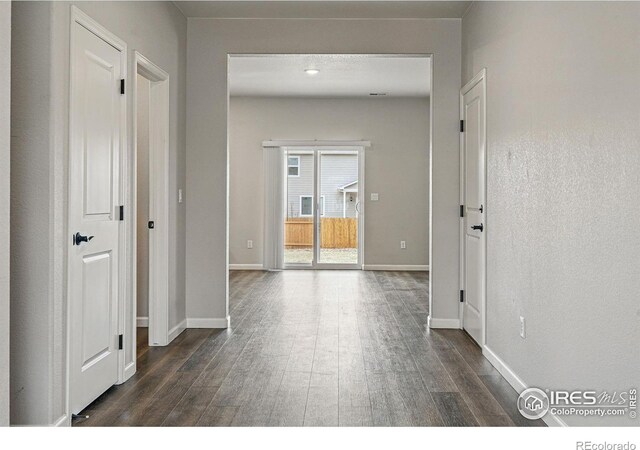 2310 Angus St, Mead, CO 80542 - corridor featuring dark wood-style floors and baseboards
