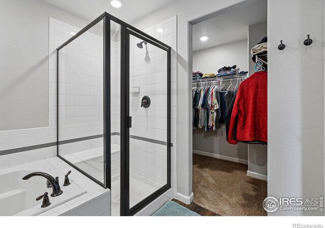 2310 Angus St, Mead, CO 80542 - bathroom featuring a stall shower, a bath, a spacious closet, and recessed lighting