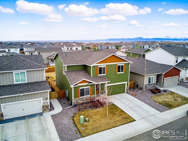 2310 Angus St, Mead, CO 80542 - traditional-style house featuring a residential view, stone siding, concrete driveway, a garage, and a shingled roof