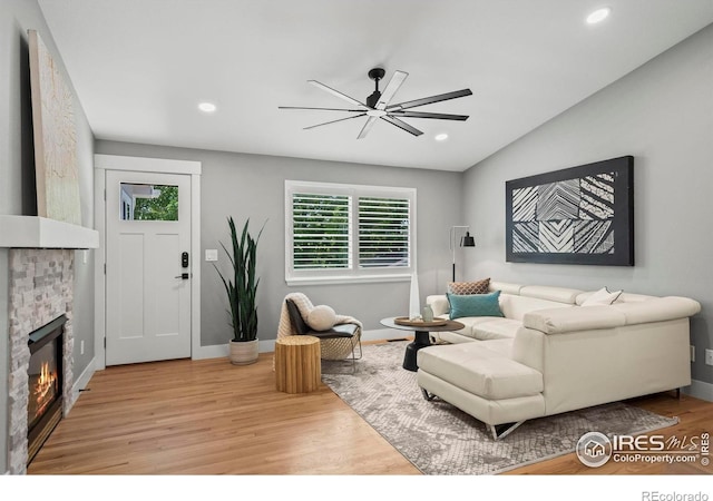 2384 Ponderosa Pl, Erie, CO 80516 - living area with ceiling fan, wood finished floors, vaulted ceiling, recessed lighting, and a fireplace