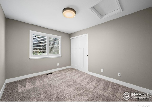 2384 Ponderosa Pl, Erie, CO 80516 - unfurnished bedroom with carpet flooring, attic access, and a closet