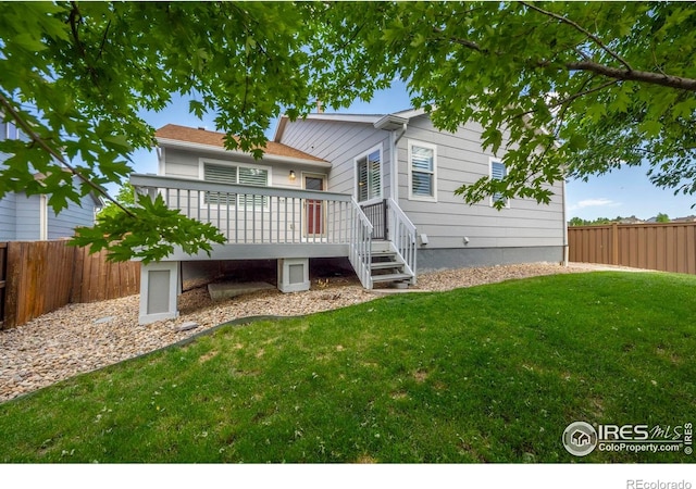2384 Ponderosa Pl, Erie, CO 80516 - rear view of house featuring a fenced backyard and a wooden deck